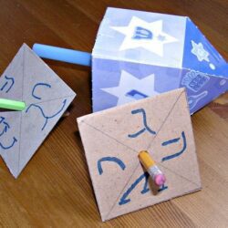 Examples of homemade paper dreidels.