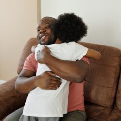 father hugs his son