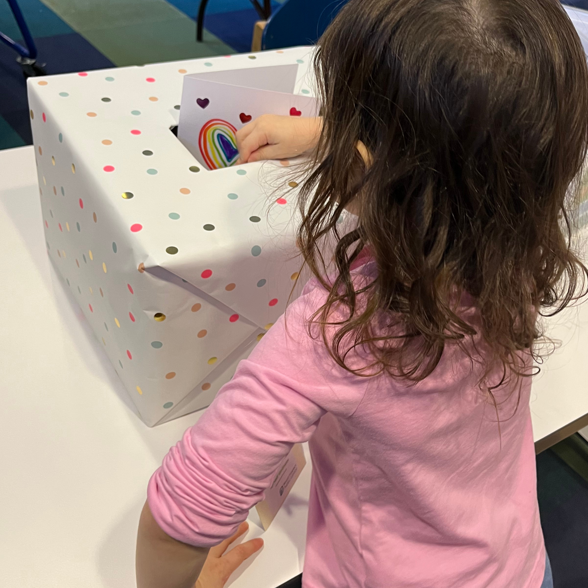 Girl putting a card in a box