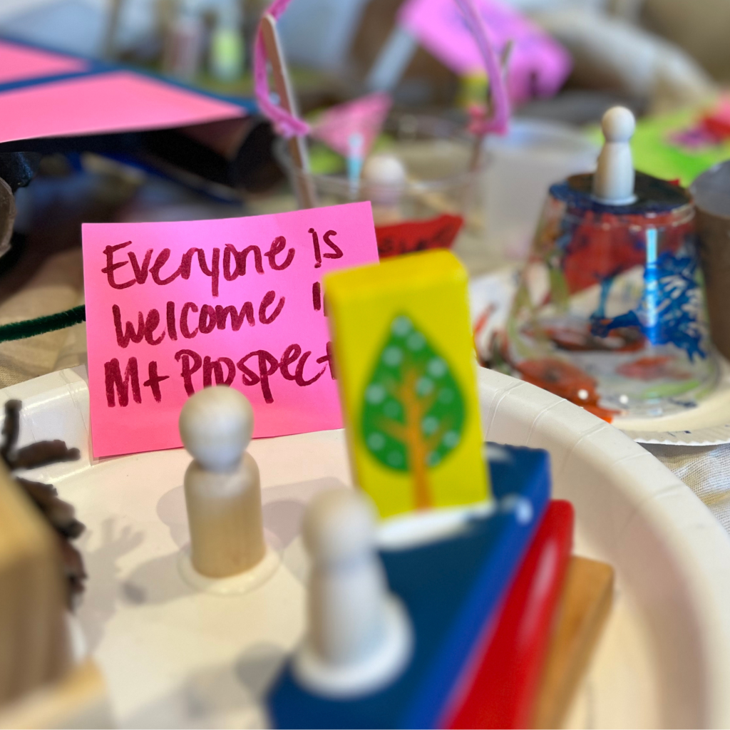 Handwritten flag reads: Everyone is welcome in Mount Prospect.