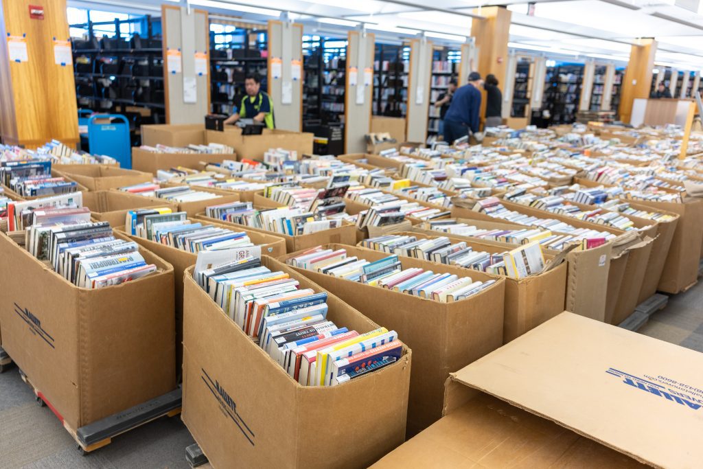 Several rows of boxes containing hundreds of books.